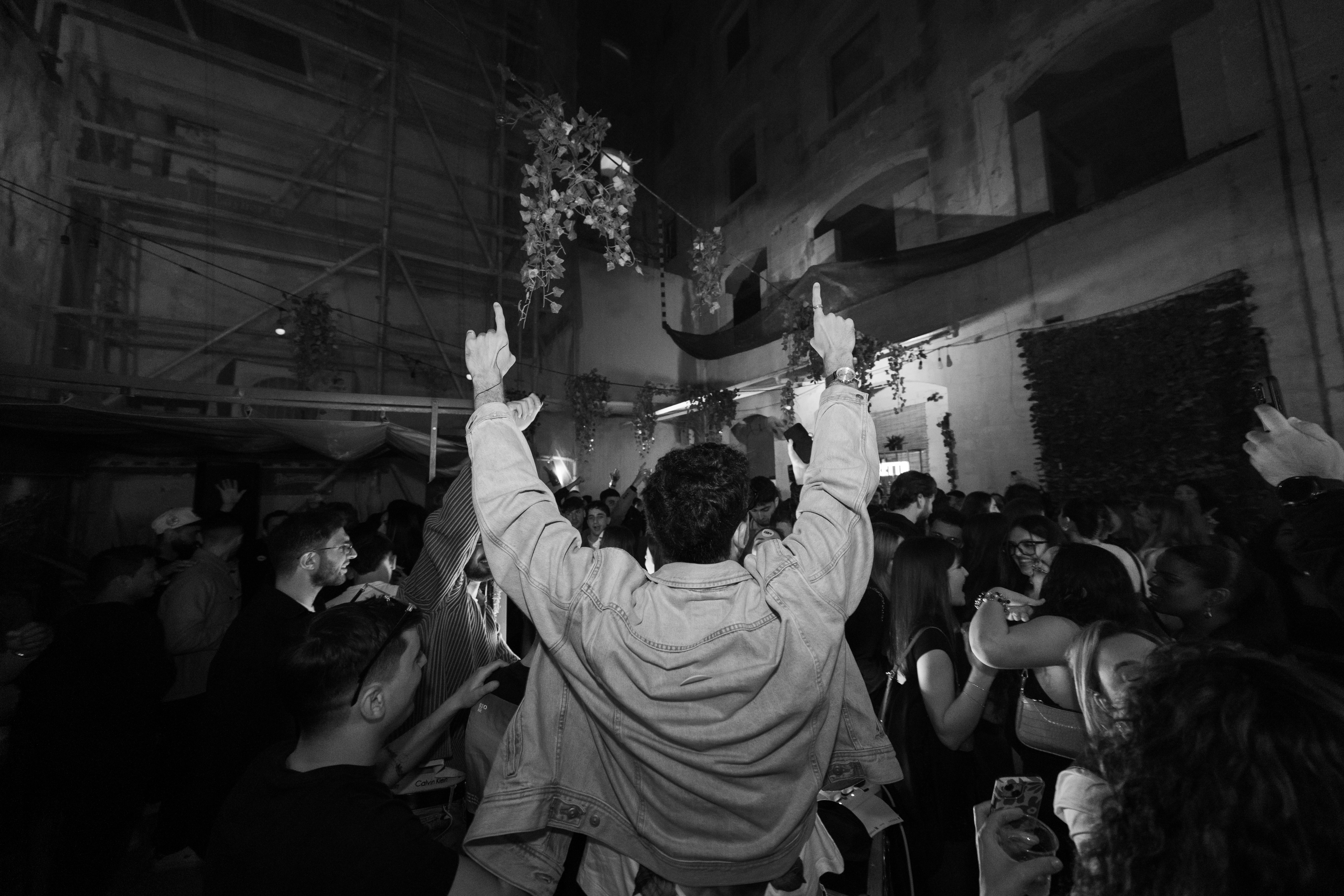 Crowd with hands up at outdoor Rakii event